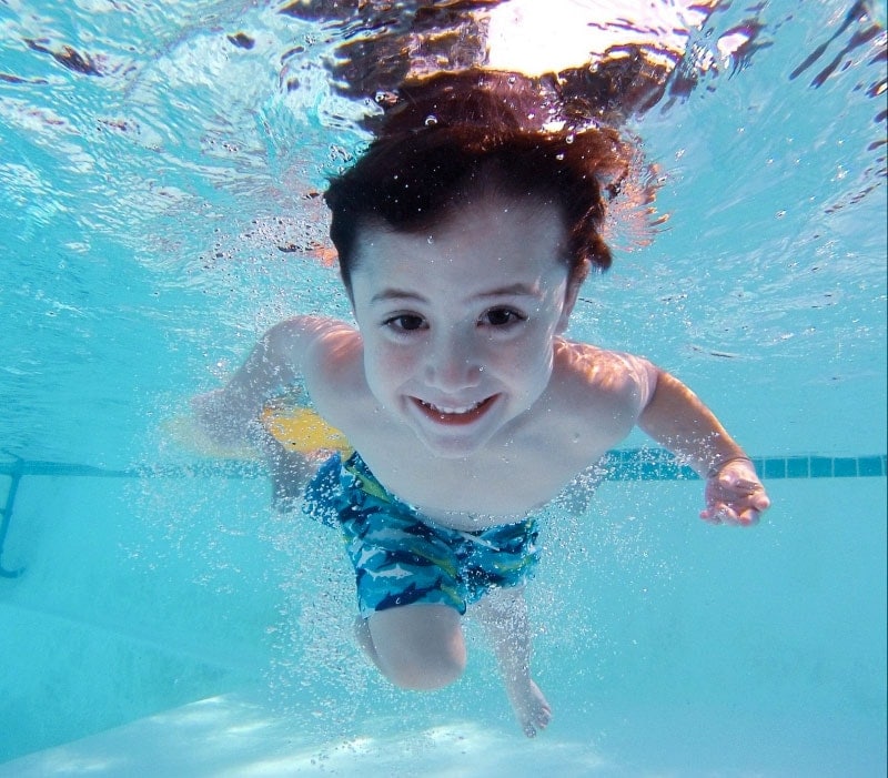 Boy swimming underwater in pool. Swim World Pools, Gallatin, TN